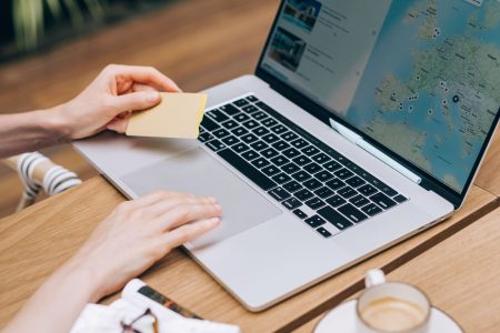 a woman booking a vacation on laptop